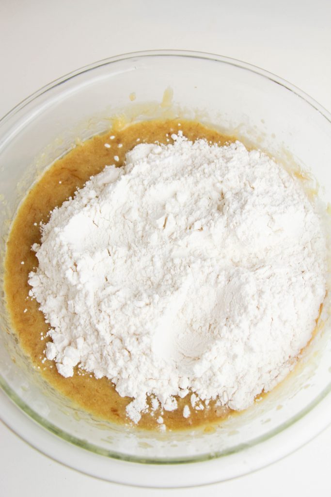 adding gluten-free flour to banana muffin batter